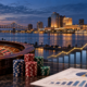Editorial illustration of Louisiana casino revenue data, a Gulf Coast skyline, and gaming charts